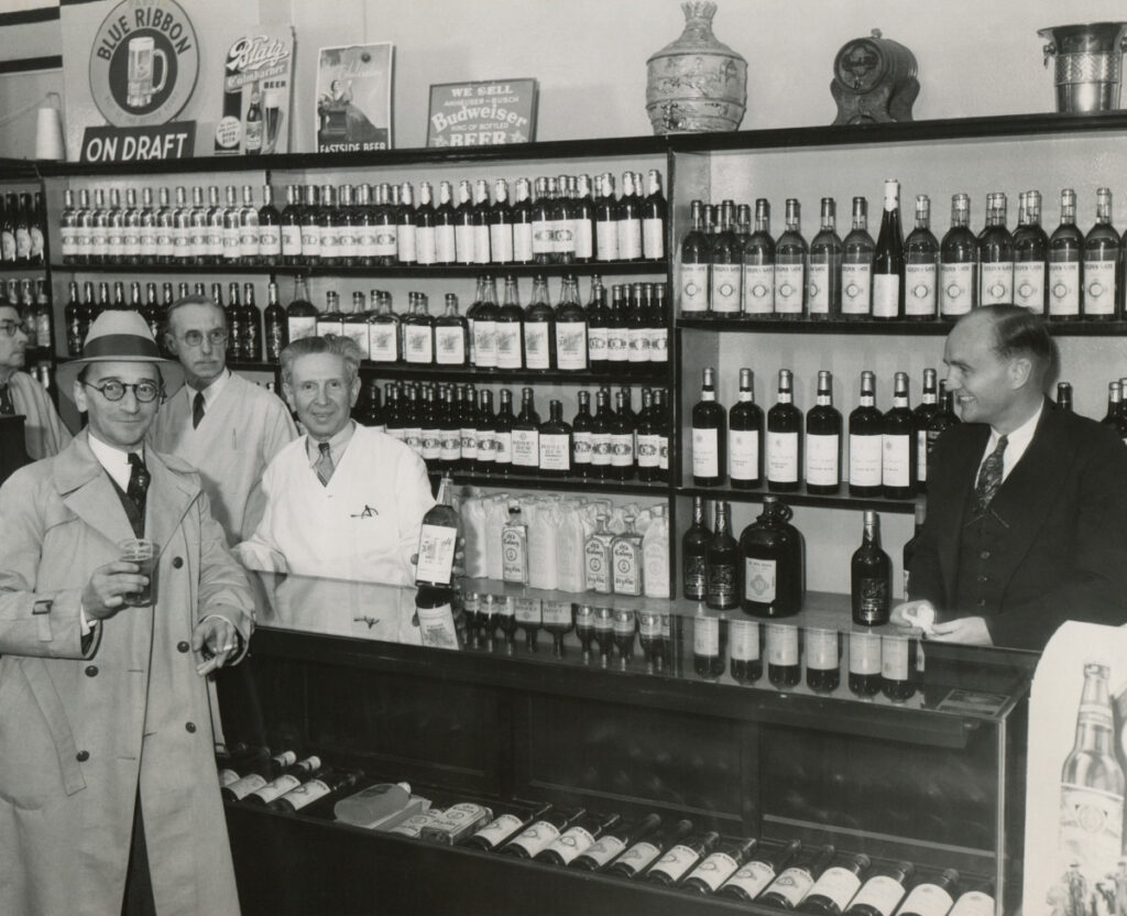 prohibition era image of a liquor store clerk selling bottle of alcohol