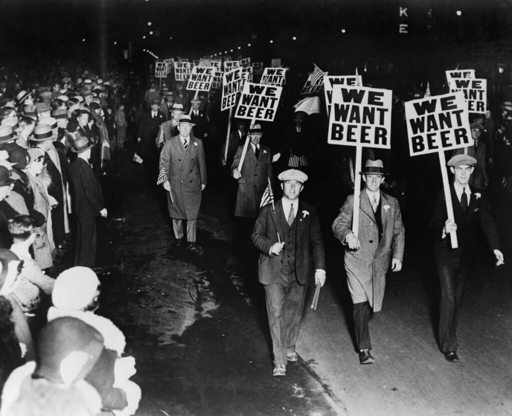 prohibition era image of men marching with signs that say we want beer